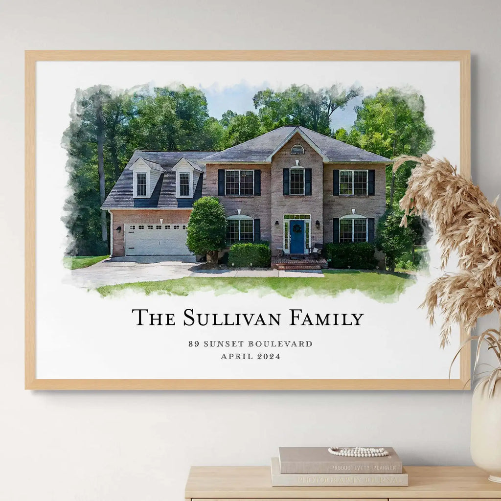 Watercolor-style portrait of a brick house with a blue door, 'The Sullivan Family', in a light oak frame above a sideboard