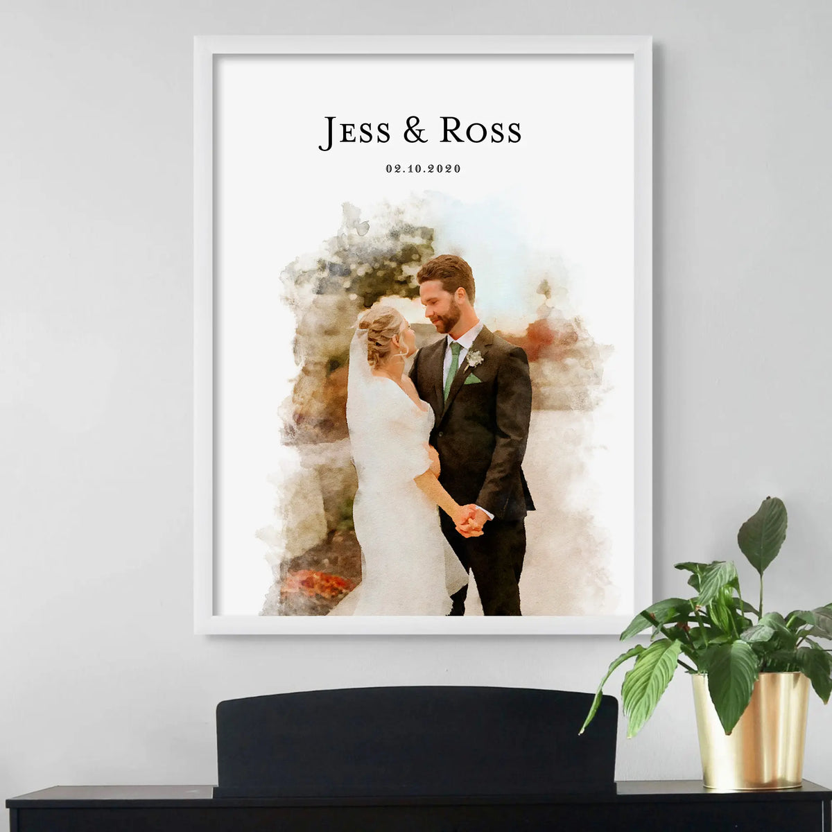 Watercolor-style portrait of a bride and groom holding hands, in a white frame, with their names and a date above