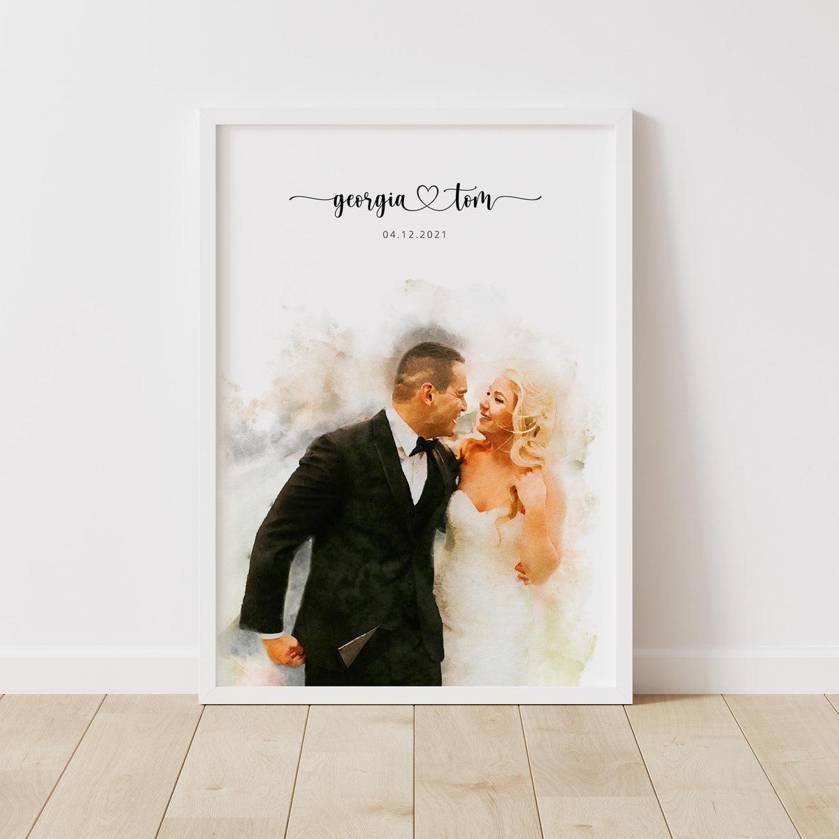 Watercolor-style portrait of a laughing couple, in a white frame on a wooden floor, their names and a date above